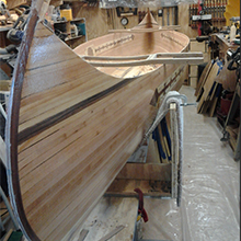 TotalBoat High Performance 2:1 Epoxy applied on a wooden canoe for clear coating.