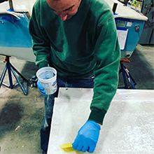 Using TotalBoat High Performance 2:1 Epoxy Resin to wet out fiberglass for a transom.